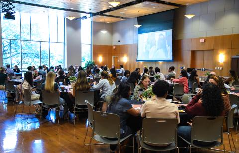 Students sitting at tables at the Research Reception