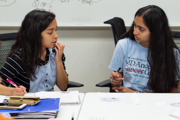Two students seated next to one another