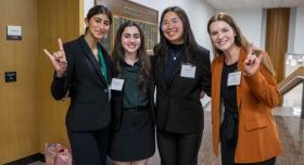 Minji Kim at conference, with group of students