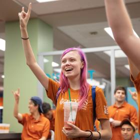 Students sing The Eyes of Texas at Gone to Undergraduate Studies