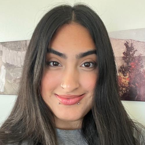 Headshot of Desi with wall art in the background