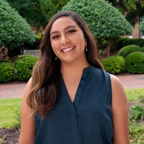 Headshot of Angeles with trees in the background