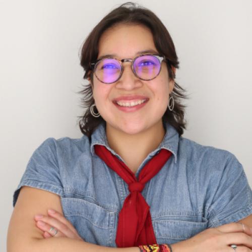 zugeily wearing a blue shirt and red tie with glasses