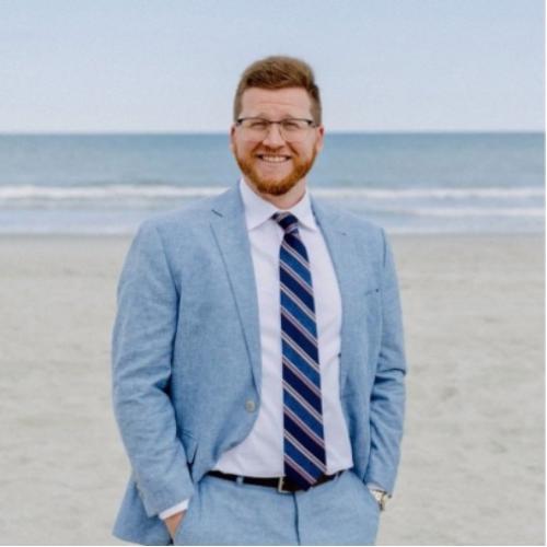 Zach in a suit at the beach