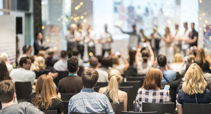 People in auditorium celebrating award recipients