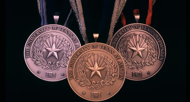 Three medals with UT and start of Texas
