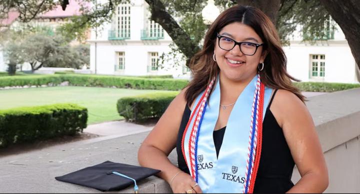 Nickoll Santos Garcia poses with her stole and other commencement attire.